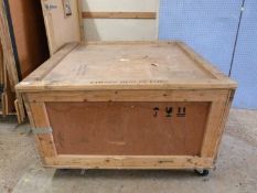 A large plywood packing crate on wheels
