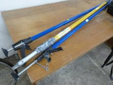 Two extendable locking props and a Purdy decorators extending pole