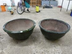 A pair of large dark green glazed ceramic planters