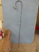 An iron shepherds crook style stand for bird feeders