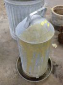 A galvanised poultry drinker