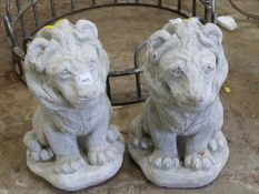 Two composite garden statues, modelled as lions