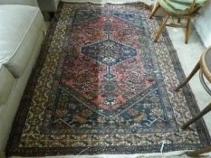 Middle Eastern wool floor rug with large central red lozenge