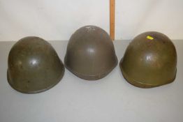 Group of three metal army helmets