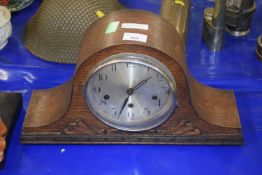 An oak cased mantel clock