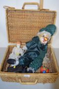 Basket containing assorted items to include porcelain headed doll, model clown, Noddy car etc