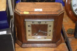 An oak cased mantel clock