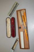 An antique cased crochet hook with polished stone handle and adjustable end fittings together with