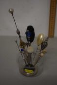 Collection of assorted hat pins and accompanying stand