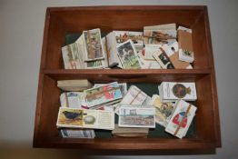 Wooden box containing assorted cigarette cards