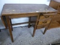 A small oak three drawer office desk with drop leaf and pull out slide