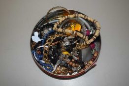 Tin of costume jewellery