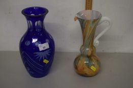 Mixed Lot: A blue overlaid cut glass vase together with a further jug (2)