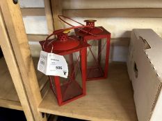 A pair of red metal lanterns