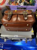 Aluminium hard shell suit case and a bowles bag