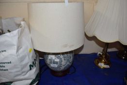 A blue and white ceramic lamp and shade