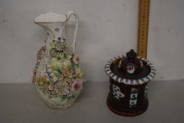 A 19th Century floral encrusted jug together with a further brown glazed tobacco jar with sprigged