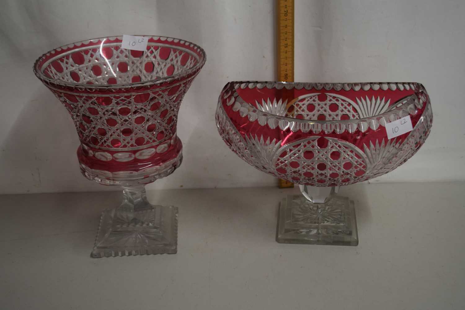 20th Century Bohemian cranberry and clear cut glass urn on square plinth base together with a