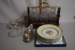 An oak and brass framed three bottled tantalus together with a quantity of assorted cutlery and a