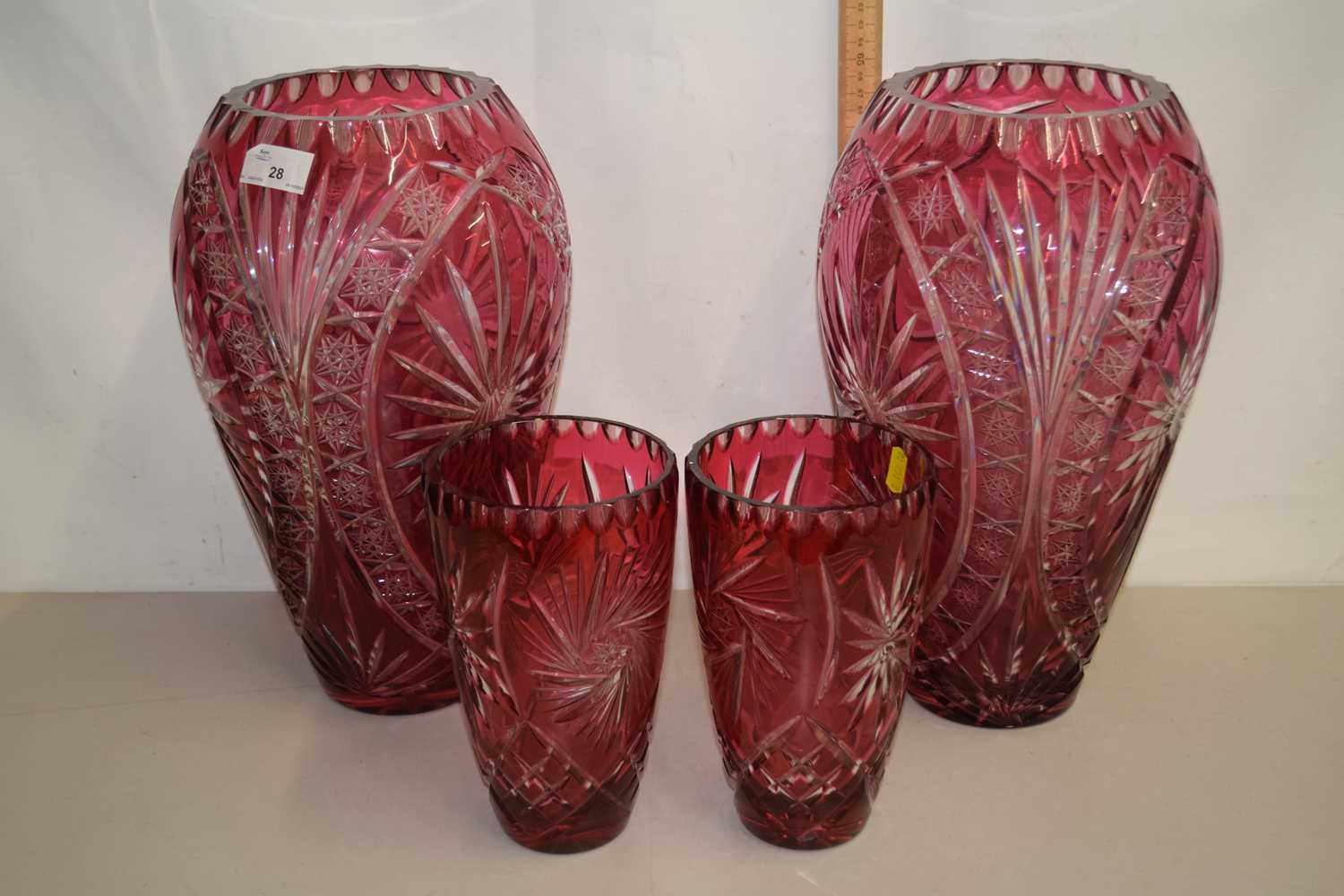 A pair of large Bohemian cranberry and clear cut glass vases of baluster form together with a