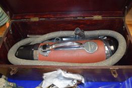 A vintage Vactric model 404 vacuum cleaner in wooden case