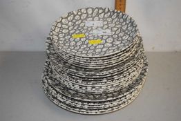 A quantity of Poole Pottery plates in the Black Pebble pattern, largest 25cm
