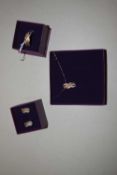 A silver and diamond necklace, earrings and ring suite: to include a tri-colour crossover pendant