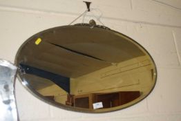 An early 20th Century oval wall mirror in Art Deco style frame
