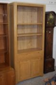 A modern oak bookcase cabinet with drawer and cupboard face, 84cm wide