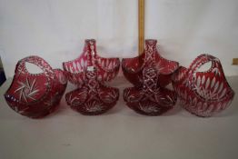 A group of six Bohemian cranberry and clear cut glass table baskets