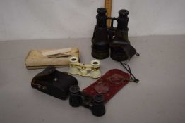 A plastic box containing a quantity of vintage binoculars including an opera example and a further