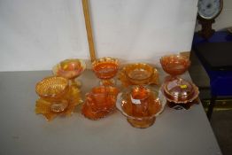 A collection of tangerine Carnival Glass