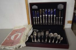 A canteen of plated cutlery with a design by Guy Degrenne in original box with metal plate for Guy