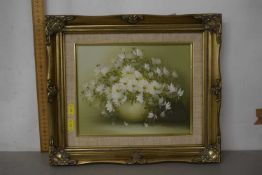 A modern picture of a vase with flowers in a gilt frame