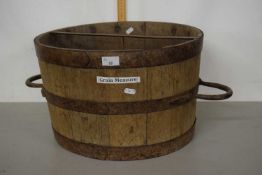 A large wooden grain measure with metal handles