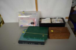 A plastic box containing a quantity of first day covers together with two stamp albums, stamps of