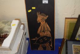 A wooden engraving of a Zulu warrior, signed lower left