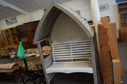 A covered garden bench with arched top