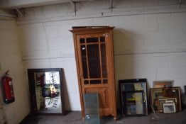 A pine cupboard with glazed front and shelves