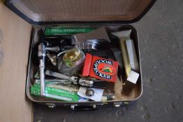 A suitcase and a quantity of bar taps and accessories