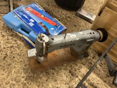 A vintage Singer sewing machine and laser level