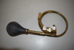 A brass model of a vintage car horn together with two Middle Easter knives
