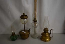 A group of four various oil lamps