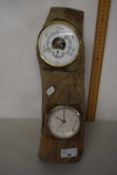 A modern wood mounted barometer and clock combination
