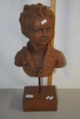 A terracotta finish composition bust raised on a plinth base