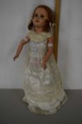 A vintage doll with articulated limbs and composition head stamped Paris 301/10