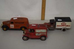 A money box modelled as a vintage car and two other money boxes