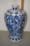 A Chinese porcelain vase with blue and white design of baluster shape decorated with dragons