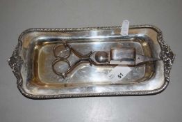 A small plated tray and pair of tongs