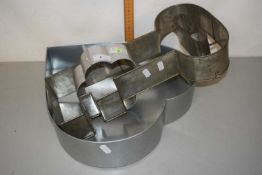 A group of three metal moulds